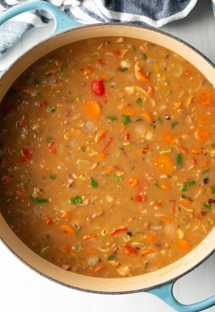 Top down view soup made with 15 beans and veggies in a large cooking pot.