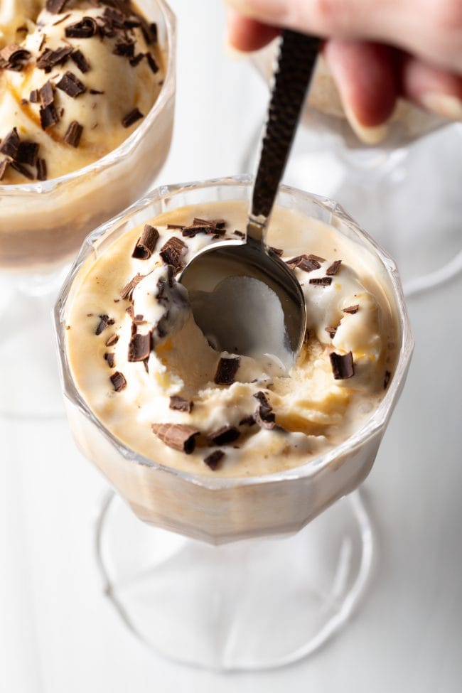 Spoon scooping into Italian gelato and espresso with chocolate shavings.