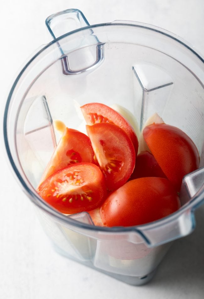 Quartered tomatoes in a blender.