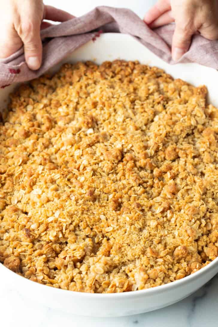 Top down view baked apple crisp with oats.