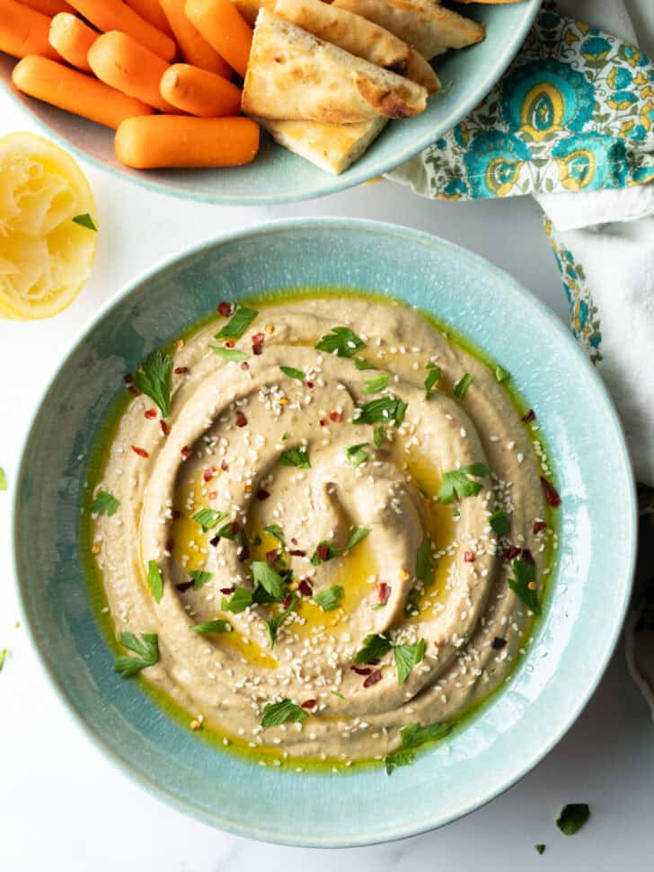 Top down view light blue bowl of baba ghanoush.