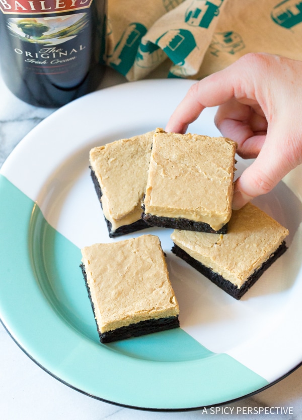 Awesome Baileys Irish Cream Coffee Bars for Saint Patrick's Day on plate with hand picking up piece