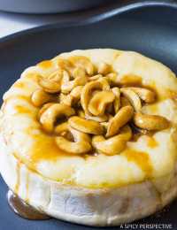 Easy Baked Brie with Cashews and Bourbon Brown Sugar Glaze Recipe on ASpicyPerspective.com. #holidays #christmas