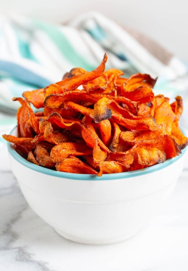 Crispy carrot chips piled high in a bowl. 