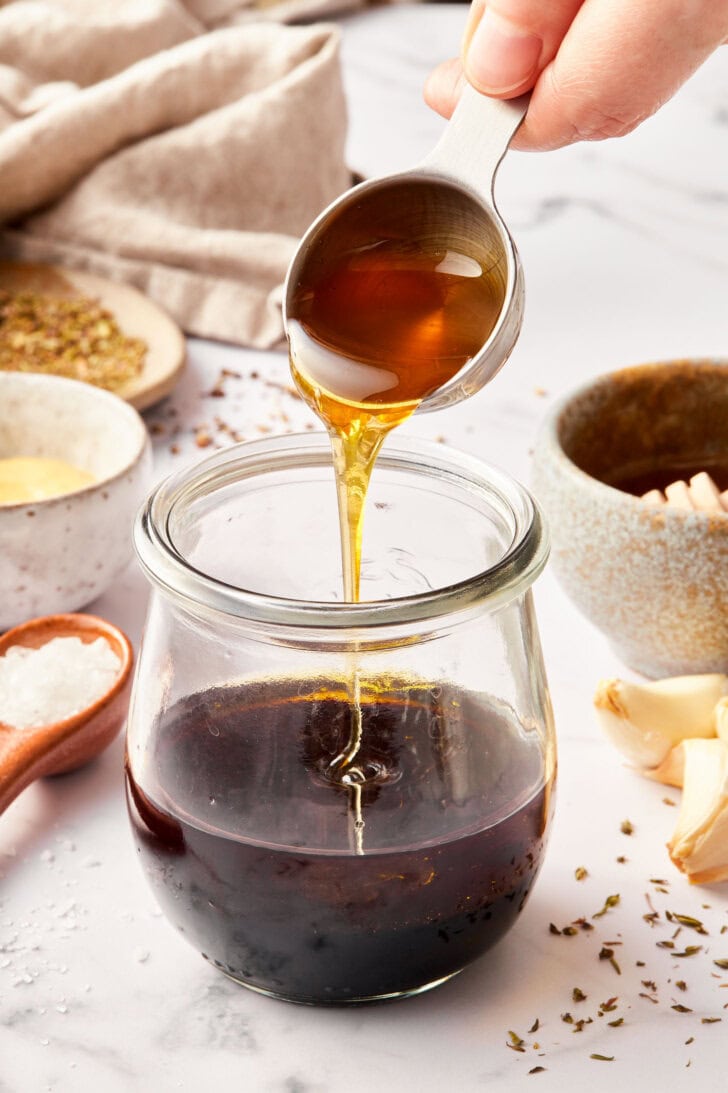 Honey being added to the balsamic vinaigrette. 