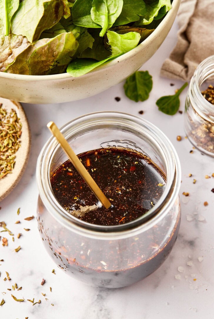 Homemade salad dressing with balsamic vinegar in jar.