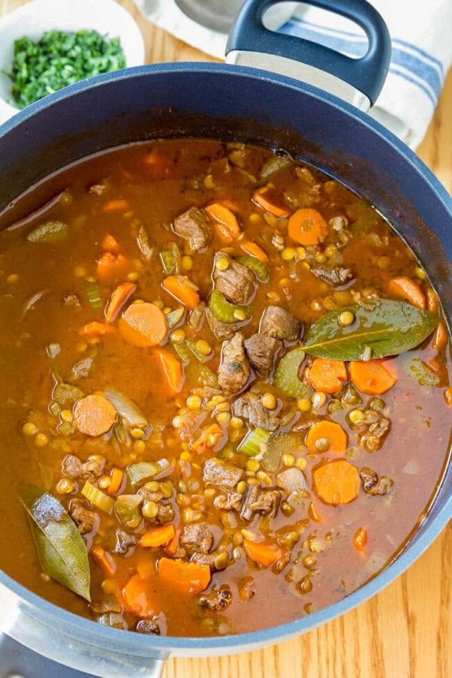 Lentil Stew in pot with beef and bay leaves