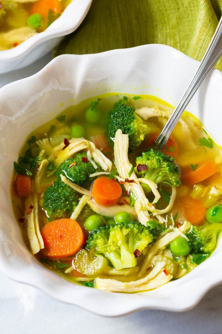 Chicken detox soup in a bowl with a spoon. 