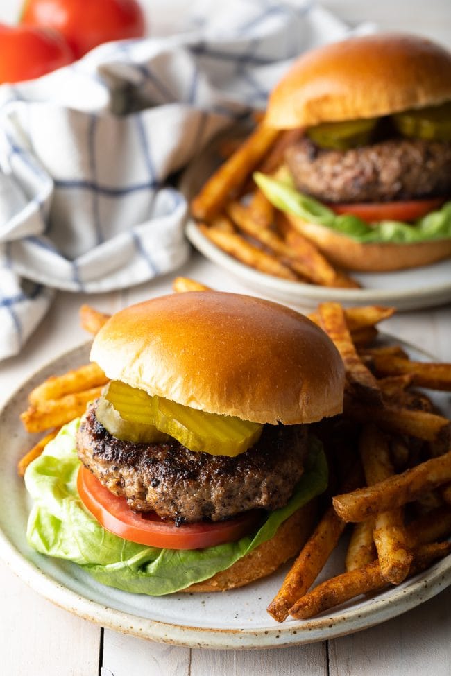 Homemade hamburger served with toppings and french fries. 