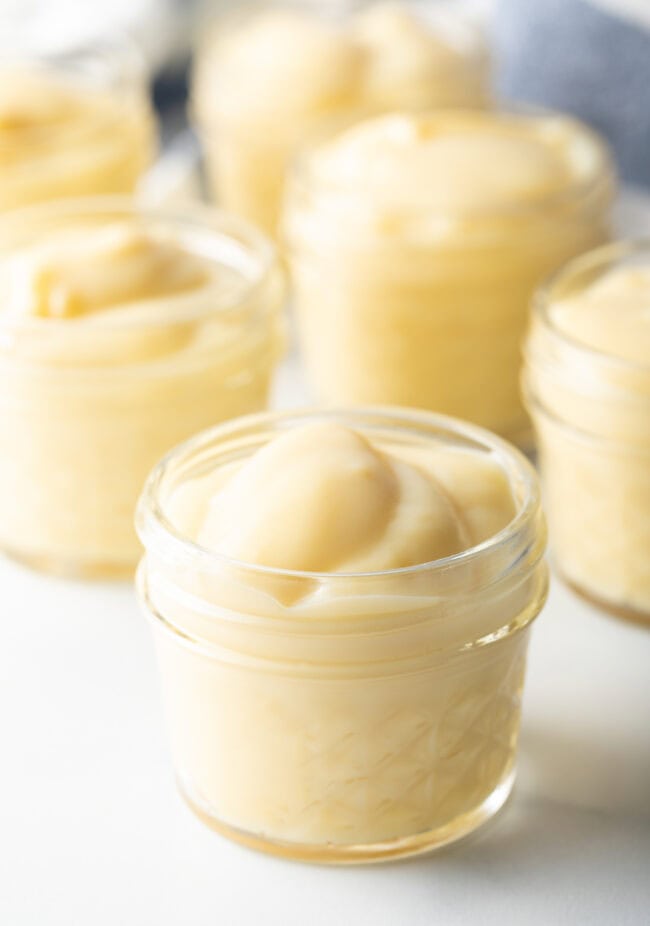 Homemade vanilla pudding in a small glass container.