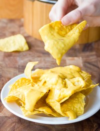 Best Queso Cheese Dip Recipe scooped up on tortilla chips