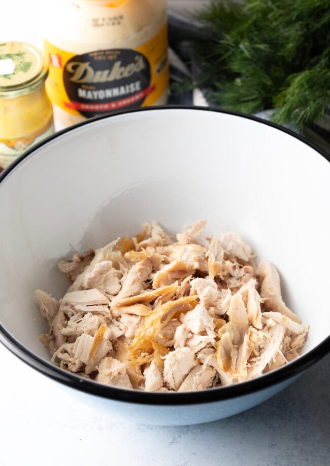 Shredded leftover turkey in a white bowl.