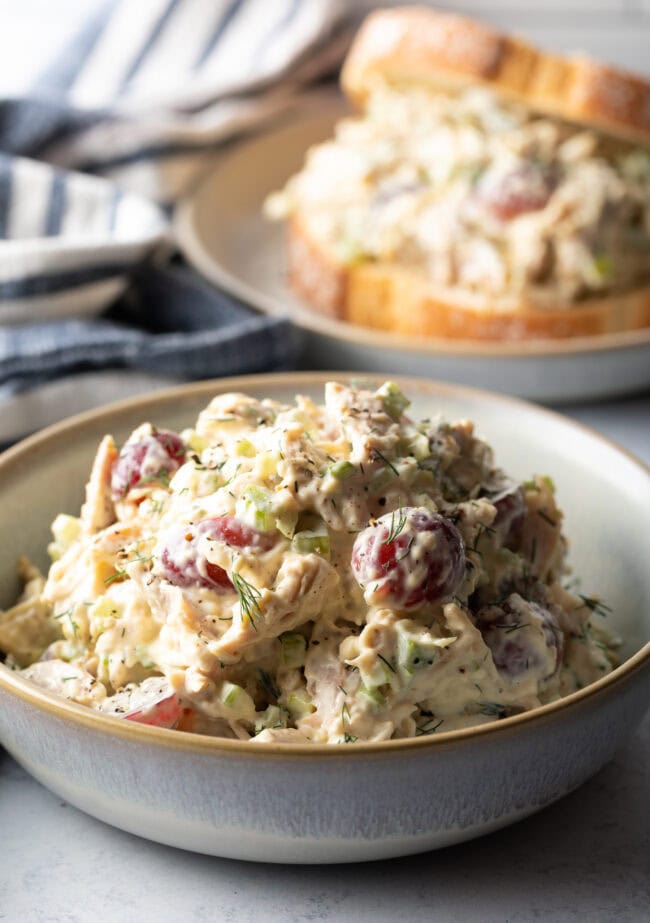 White bowl loaded up with turkey salad. Main shot of leftover turkey recipe post.