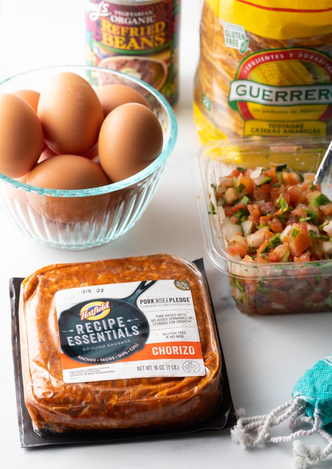 Recipe ingredients: Package of chorizo, whole eggs, container of pico de gallo, bag of flat corn shells.