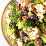 Top down view of broccoli and cauliflower salad in a large bowl