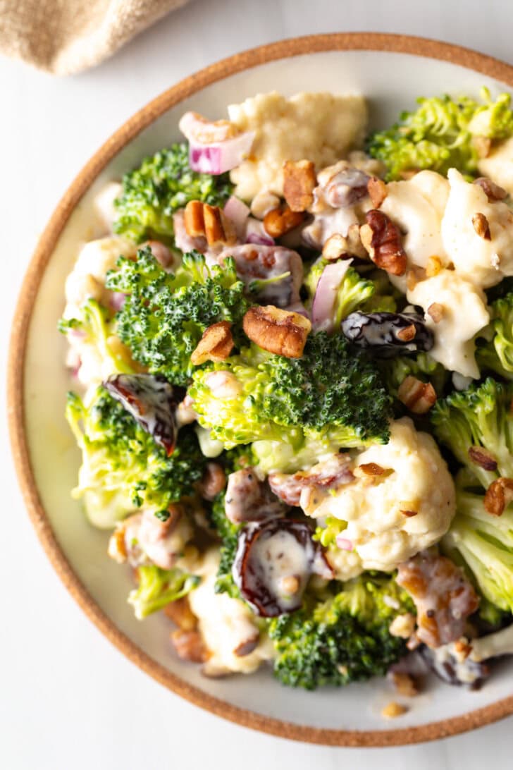 Top down view of broccoli and cauliflower salad in a large bowl