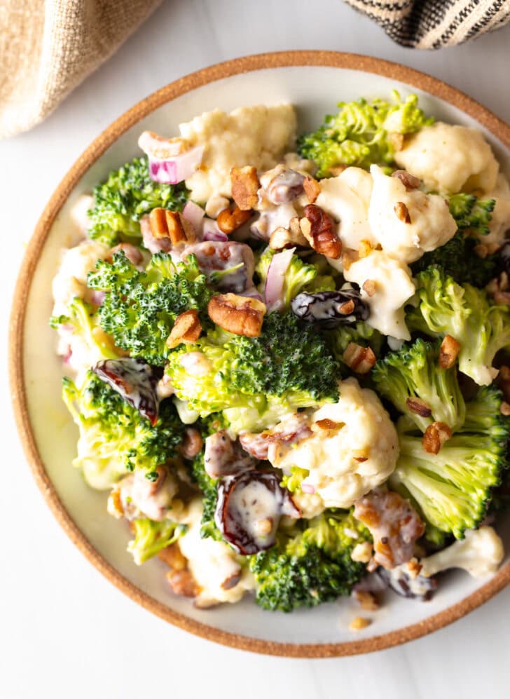 Top down view of broccoli and cauliflower salad in a large bowl