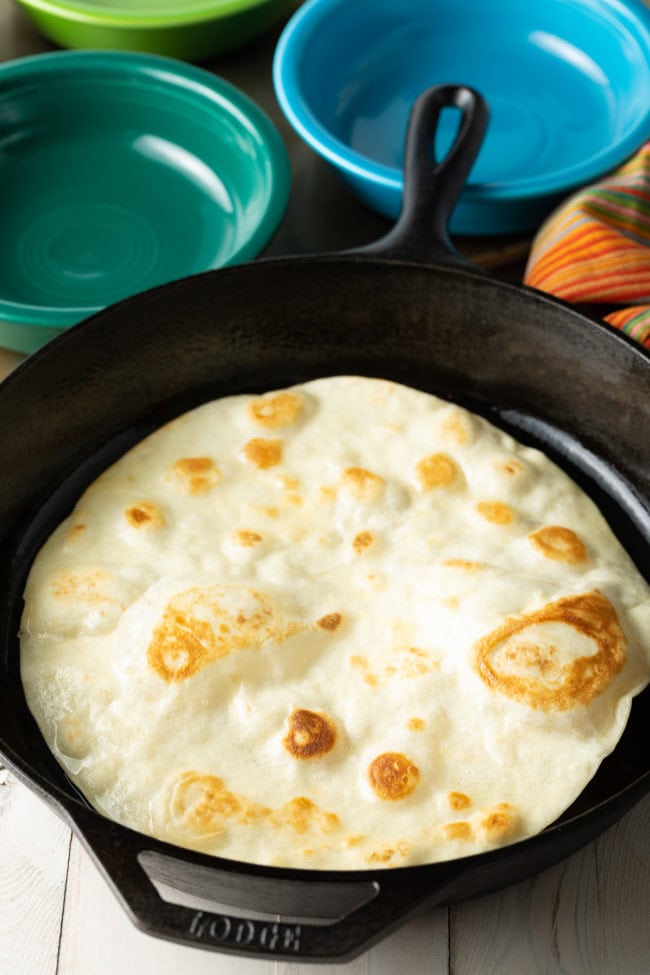 Frying Tortillas in skillet for taco bowl shells.