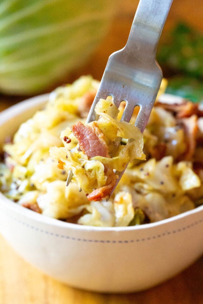 Boiled Cabbage Recipe in bowl with forkful coming up