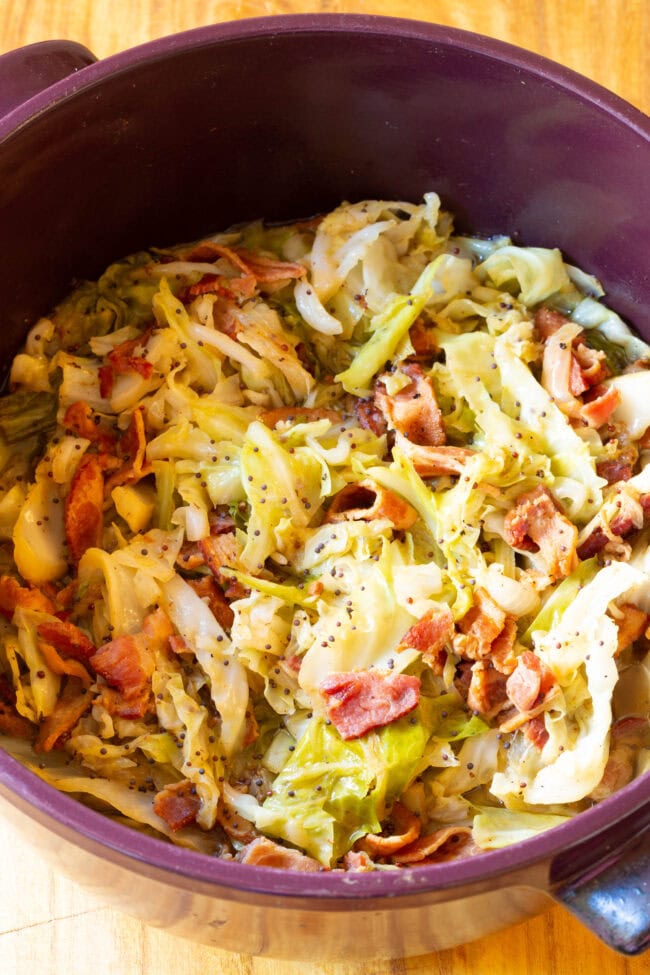 Irish bacon with cabbage cooked down in pot.