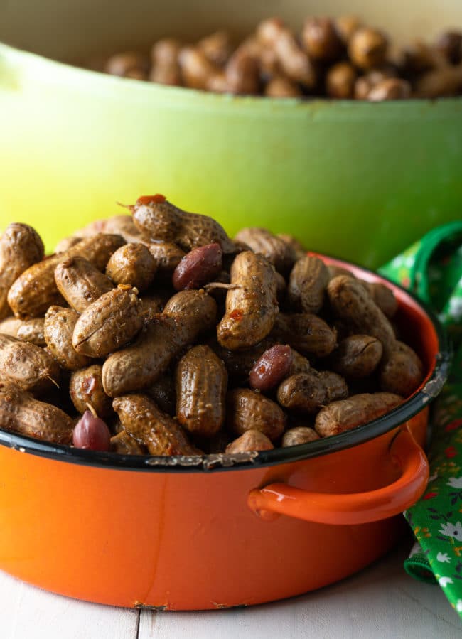 Orange pot filled to the brim with boiled peanuts. 