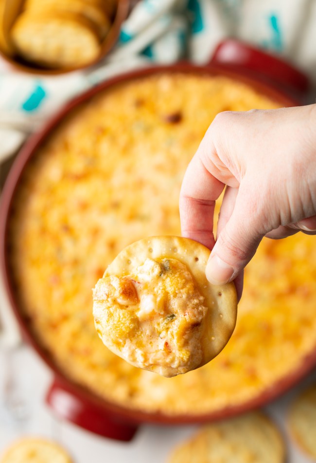 a cracker is loaded with this cajun dip