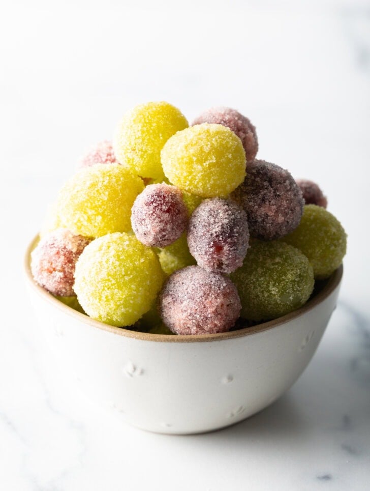 A bowl of green and purple candy grapes.