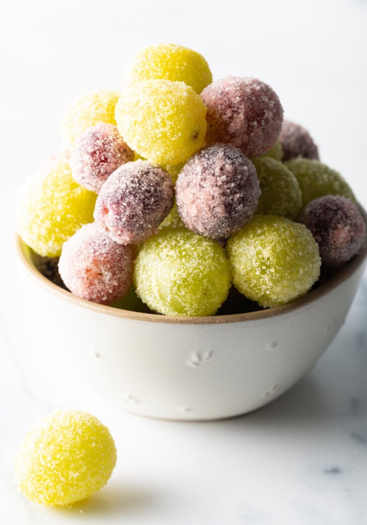 A bowl of green and purple candy grapes.