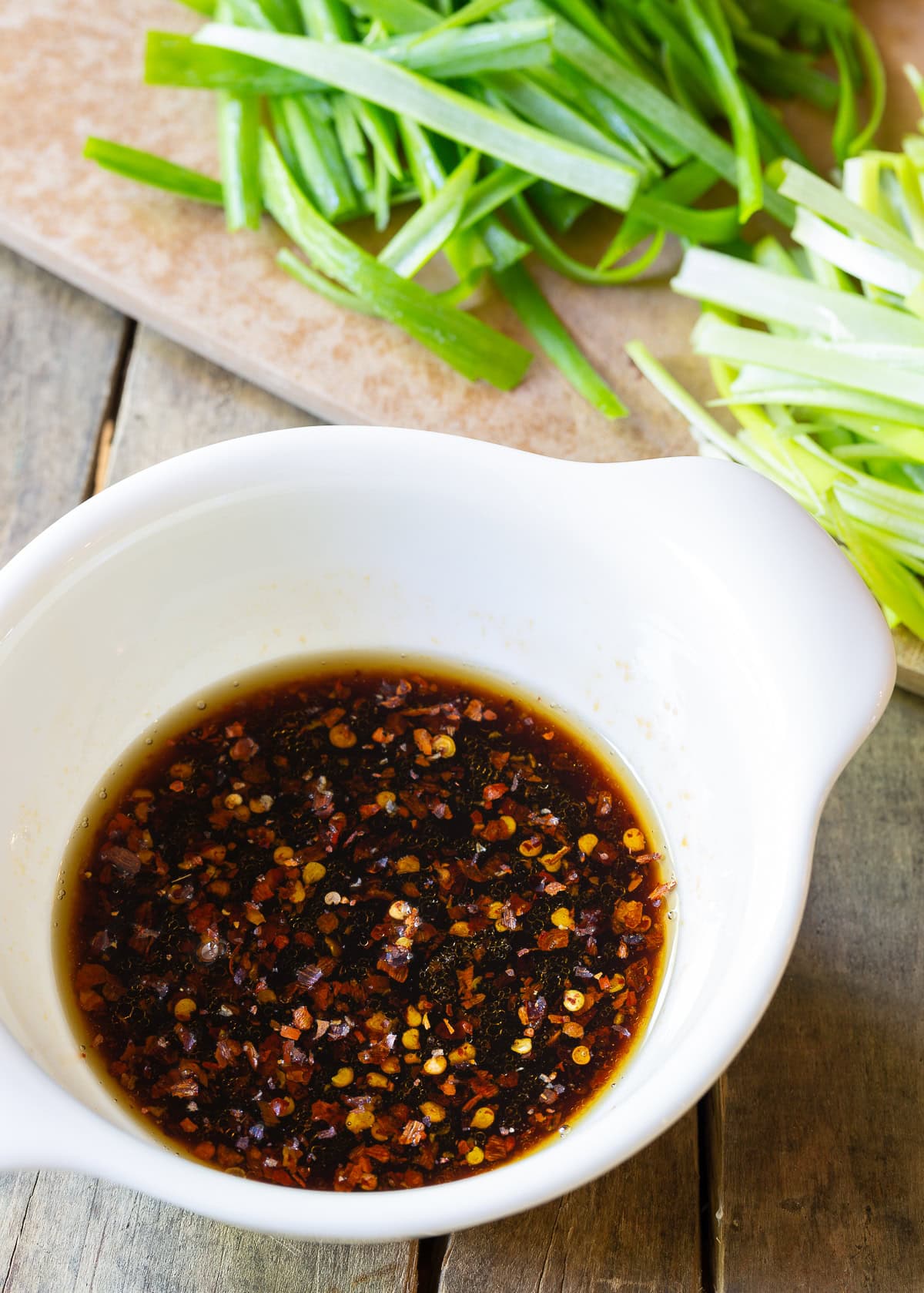 Sauce for pork lo mein in a white bowl. 