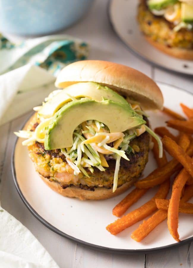 Shrimp Burger Recipe on plate with avocado and slaw