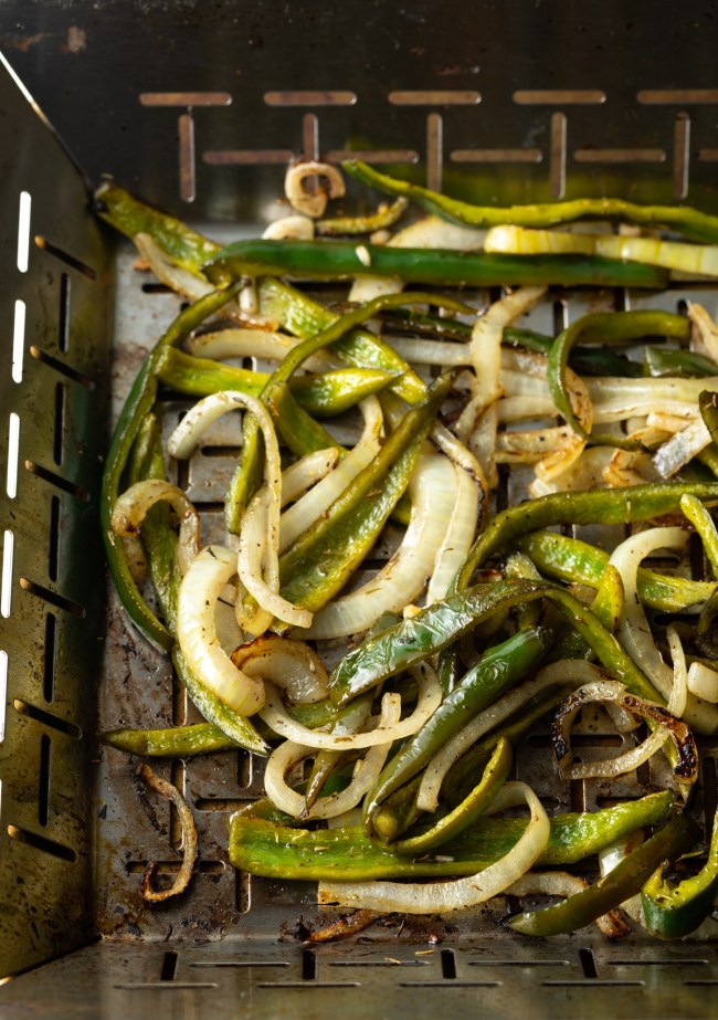 grilled peppers and onions in grill basket
