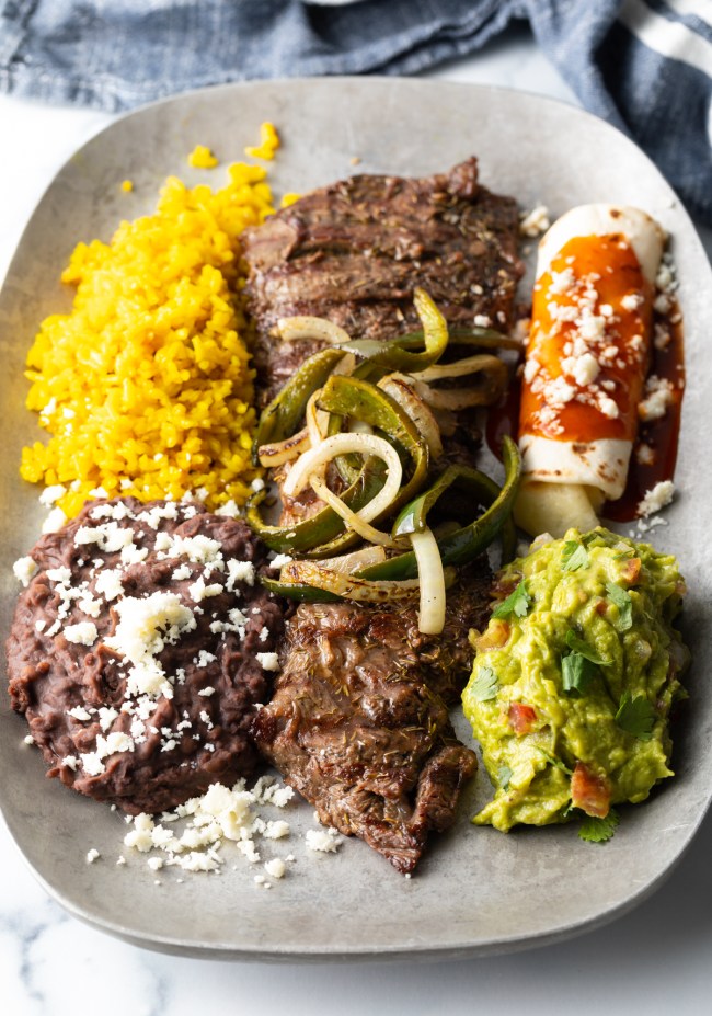 Mexican Tampiqueña Steak with classic side dishes like beans and rice