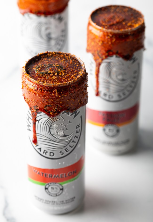 White claw watermelon hard seltzer cans with chamoy rim dip.
