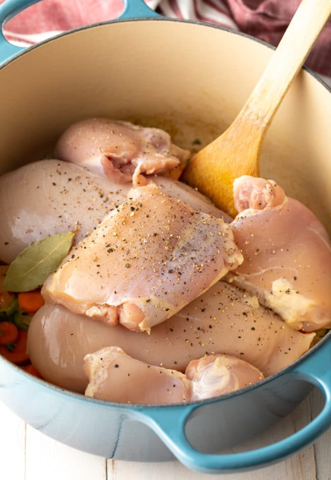 Raw chicken in a pot to make chicken and dumplings. 