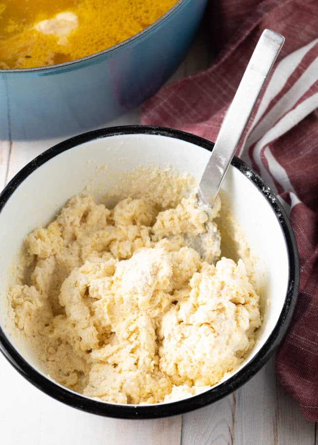 Dumpling Dough in a bowl with a metal spoon.