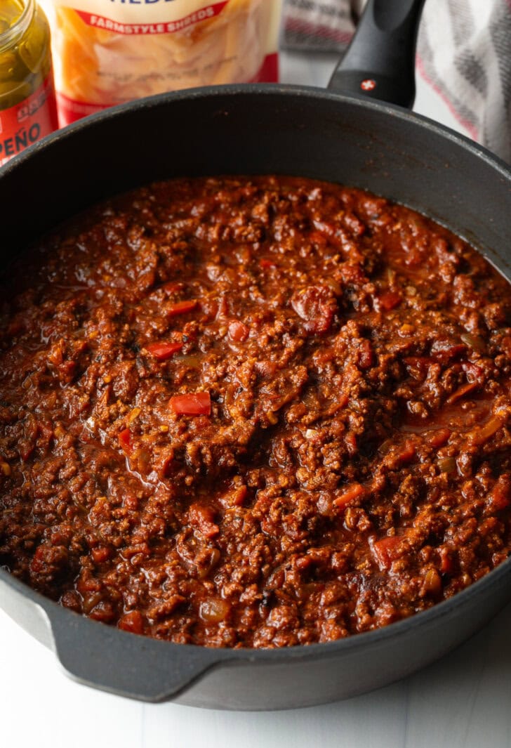 Deep cast iron skillet with homemade chili.