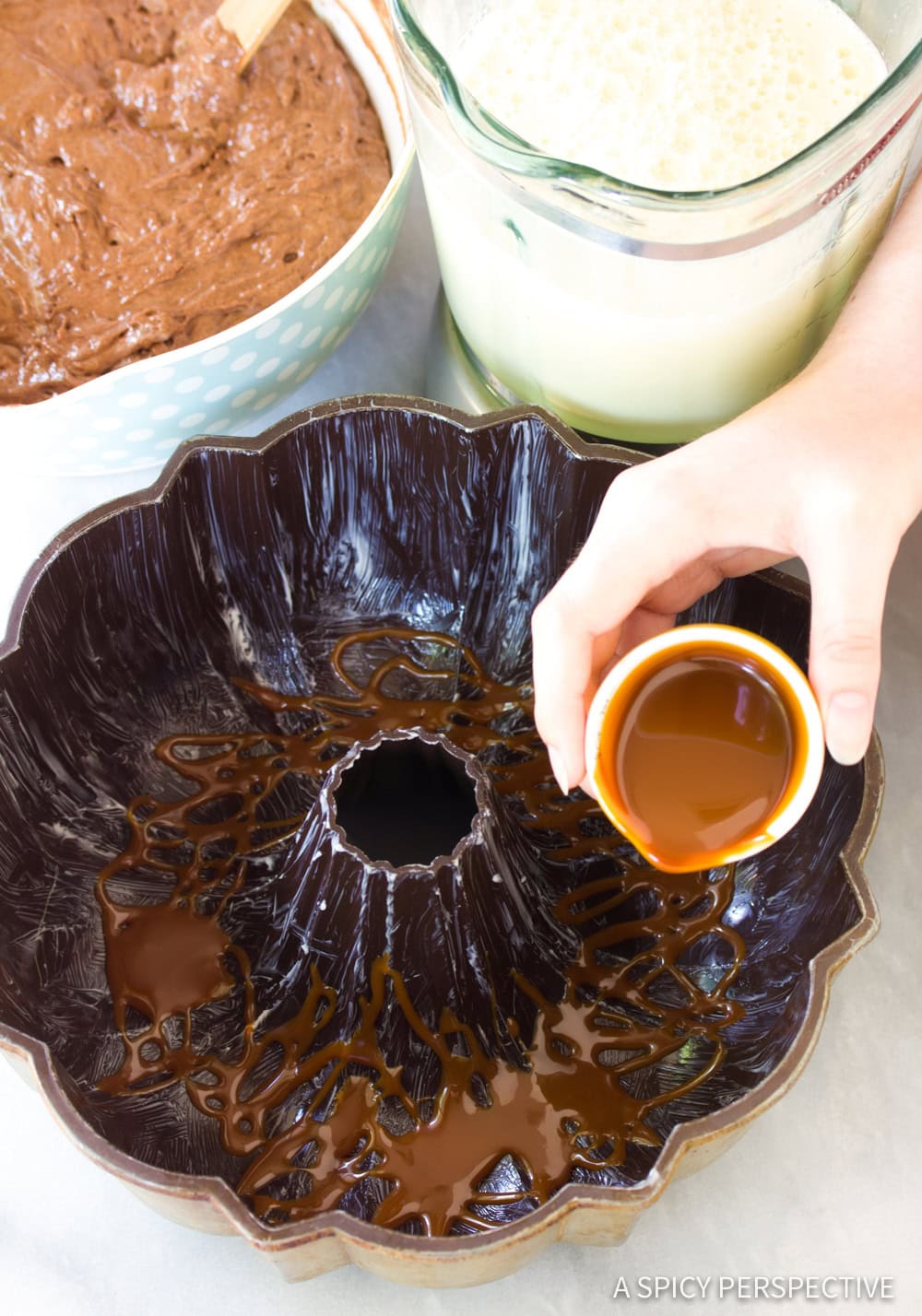 Chocoflan Recipe - Caramel being drizzled in the bottom of a greased bundt pan. 