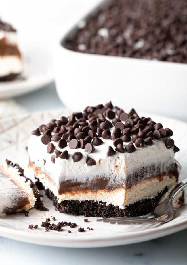 slice of no-bake chocolate lasagna pudding cake with bite taken