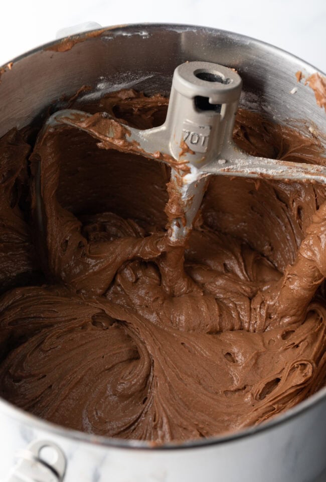 Cake batter in a metal mixing bowl.