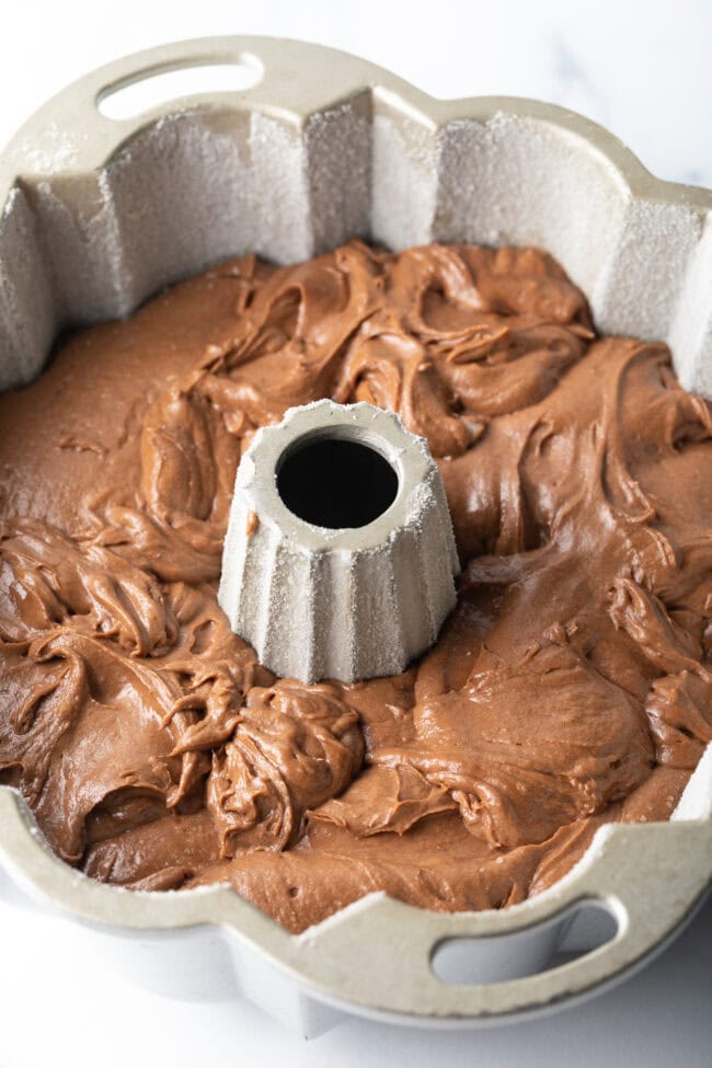 Chocolate batter poured into a bundt pan.