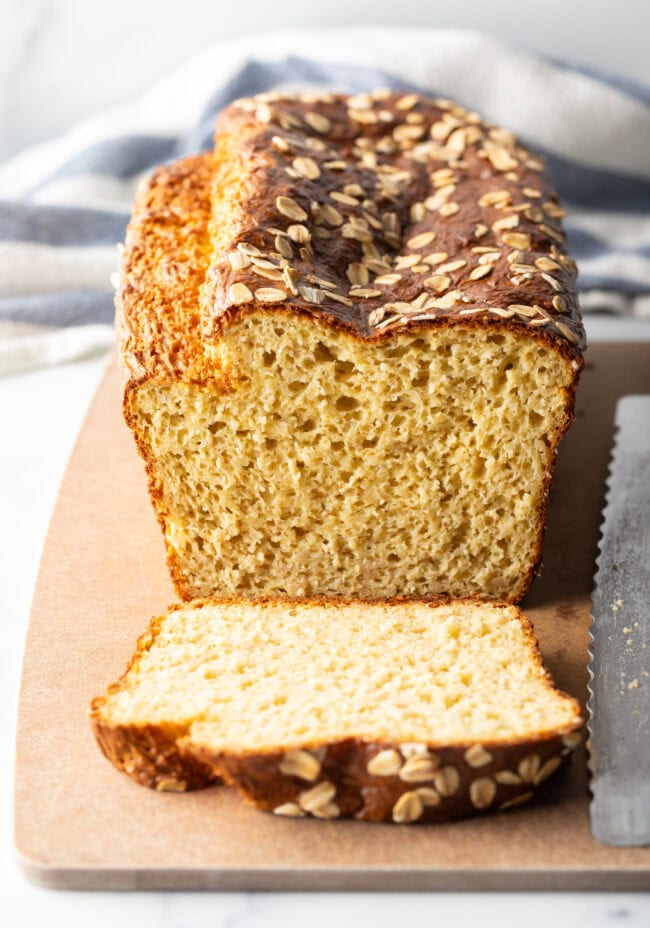 Loaf of no flour bread, one piece sliced to show inside of the loaf.