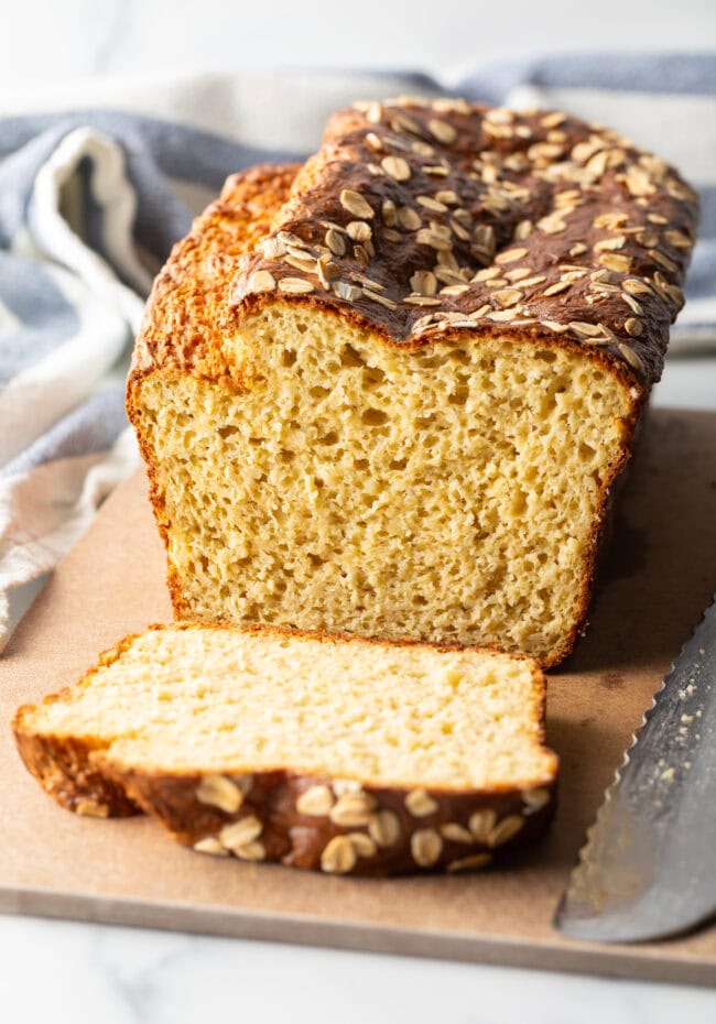 Loaf of cottage cheese bread, one piece sliced to show inside of the loaf.