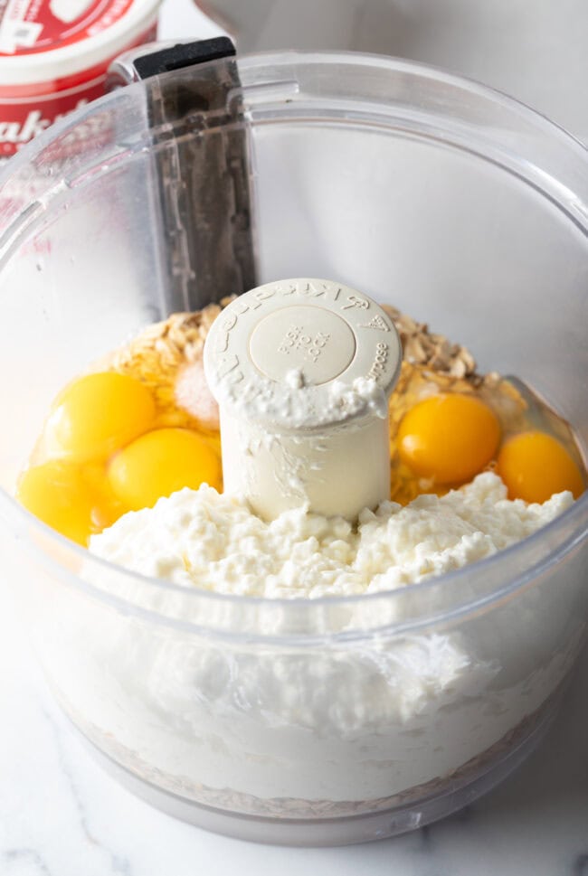 Eggs, cottage cheese, and oats in a food processor.