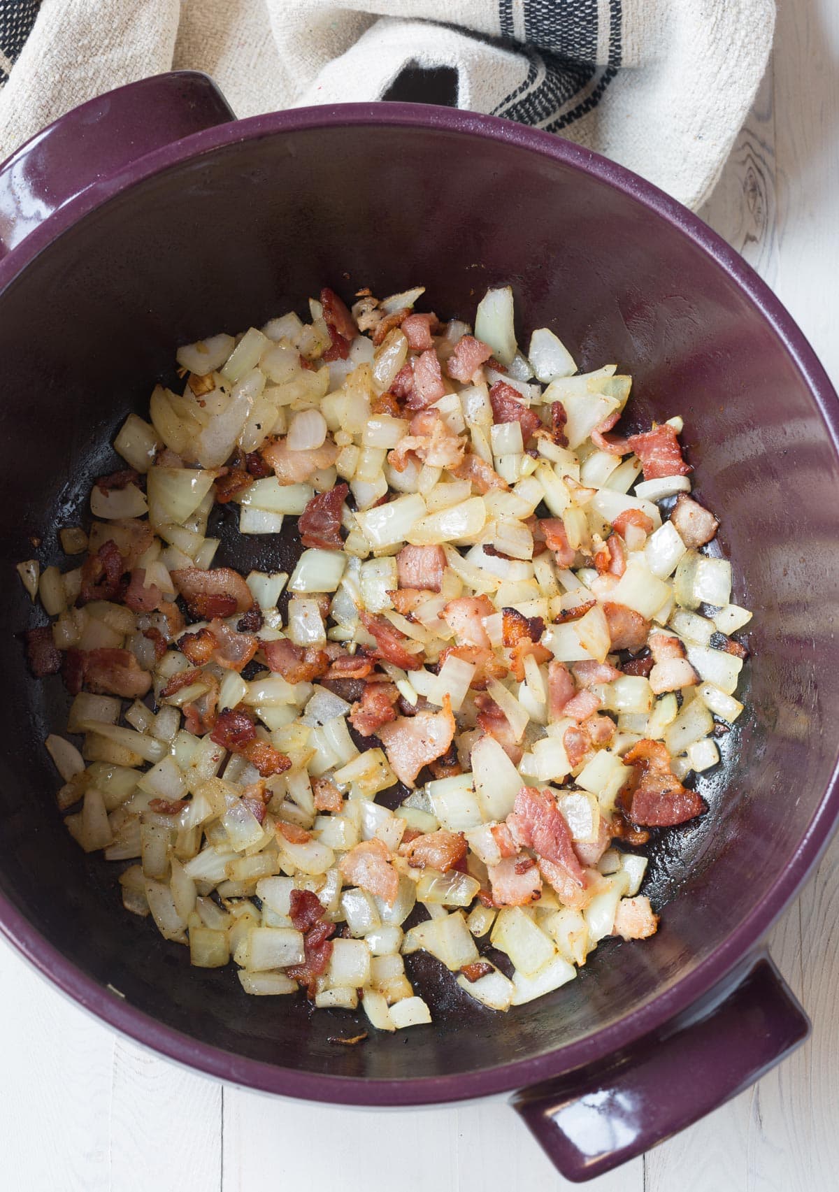 Making Creamy Coq au Vin Recipe - bacon and onions sauteed in pot