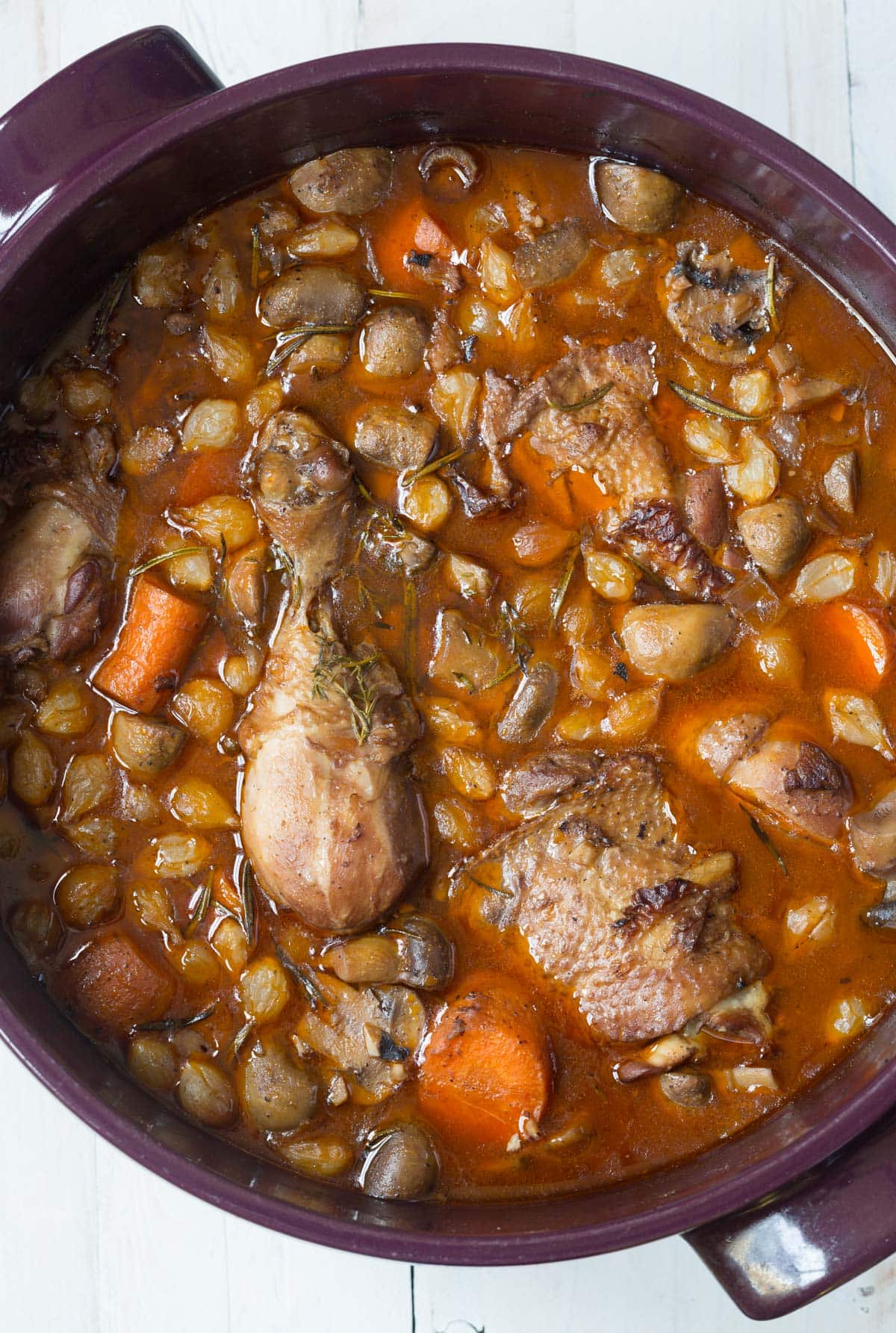 Coq au Vin stew - overhead shot in pot with chicken pieces