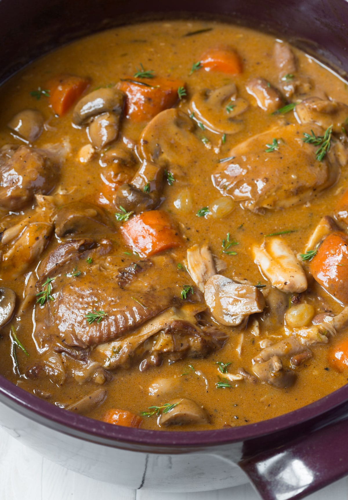 Chicken and wine stew in mushroom sauce pot 