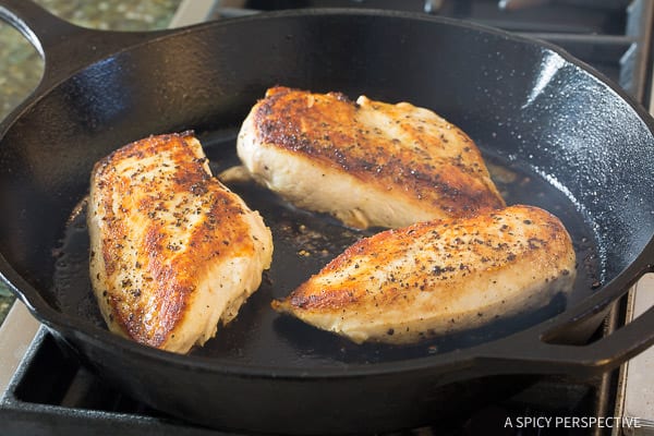 Easy Creamy Roasted Red Pepper Chicken Skillet Recipe - searing chicken in the skillet