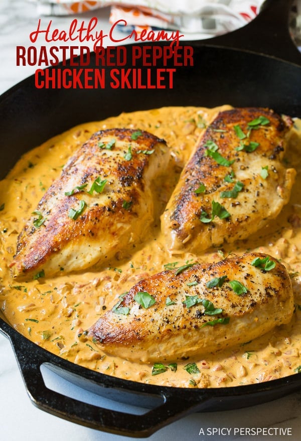 Roasted Red Pepper Chicken  - saucy chicken sizzling in a large cast iron skillet