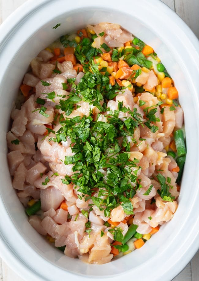 All ingredients for chicken pot pie in the crockpot. 