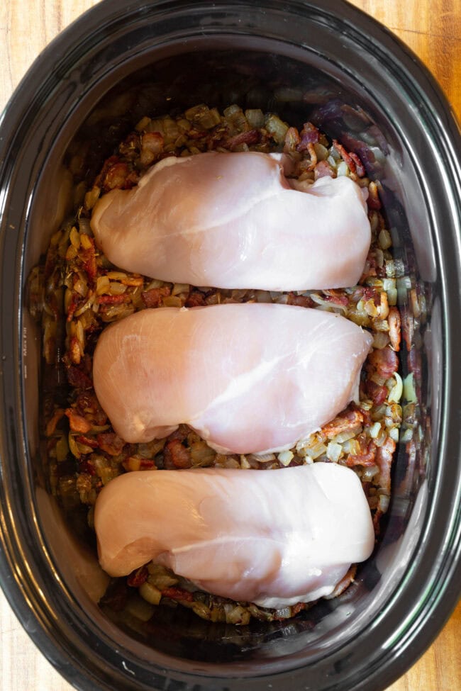 Veggies and raw chicken in the crock pot for chicken potato soup